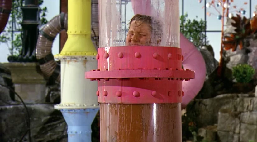 A person trapped inside a transparent pipe filled with liquid